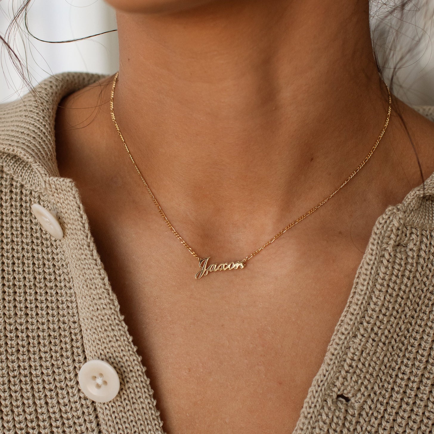 Model wearing gold Nayru Name Necklace