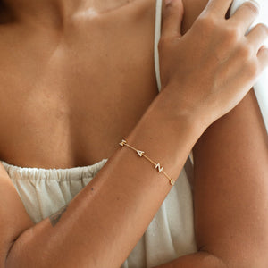Model wearing sideways letters name bracelet
