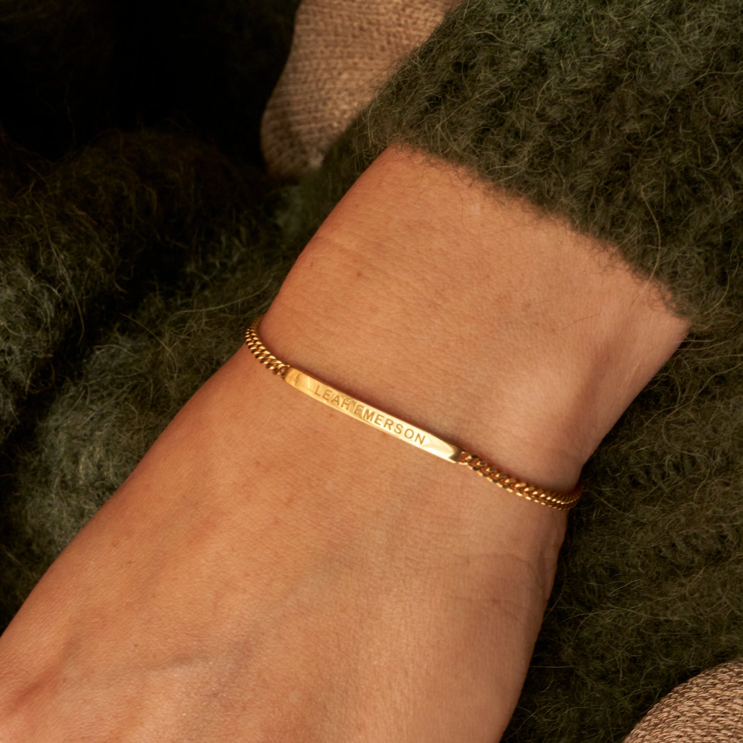 Custom engraved name on a dainty bar bracelet with gold curb chain
