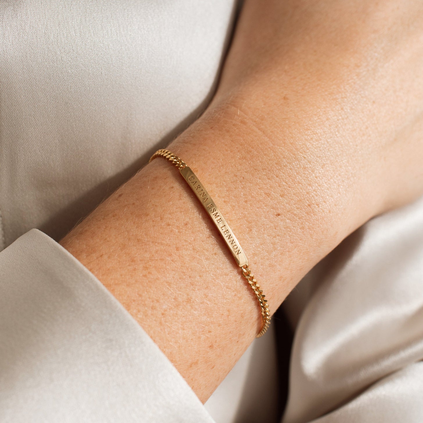 Model wearing the Dana Engraved Bar Bracelet by Grace Personalized