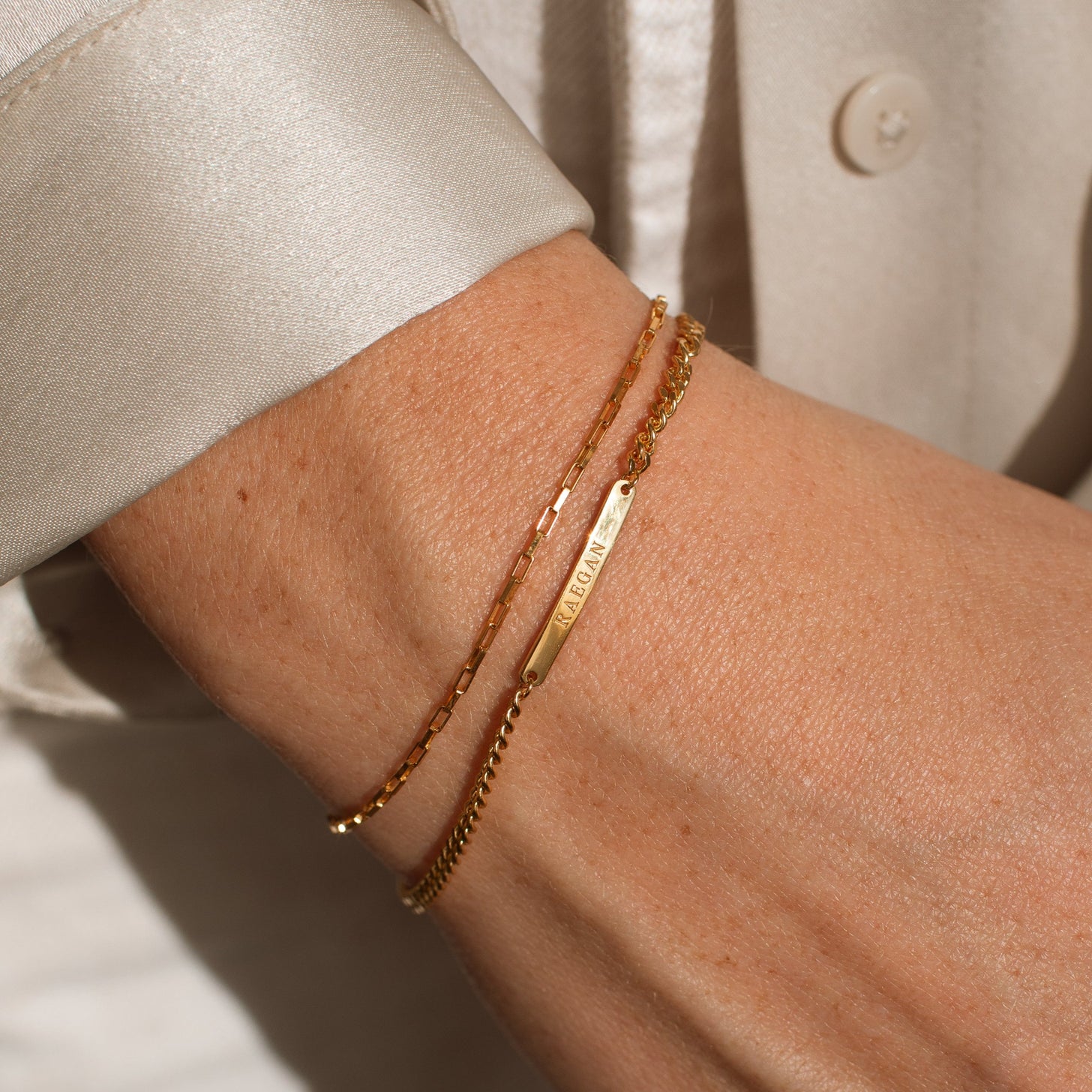 The Darcy Engraved Bracelet paired with a mini link chain bracelet