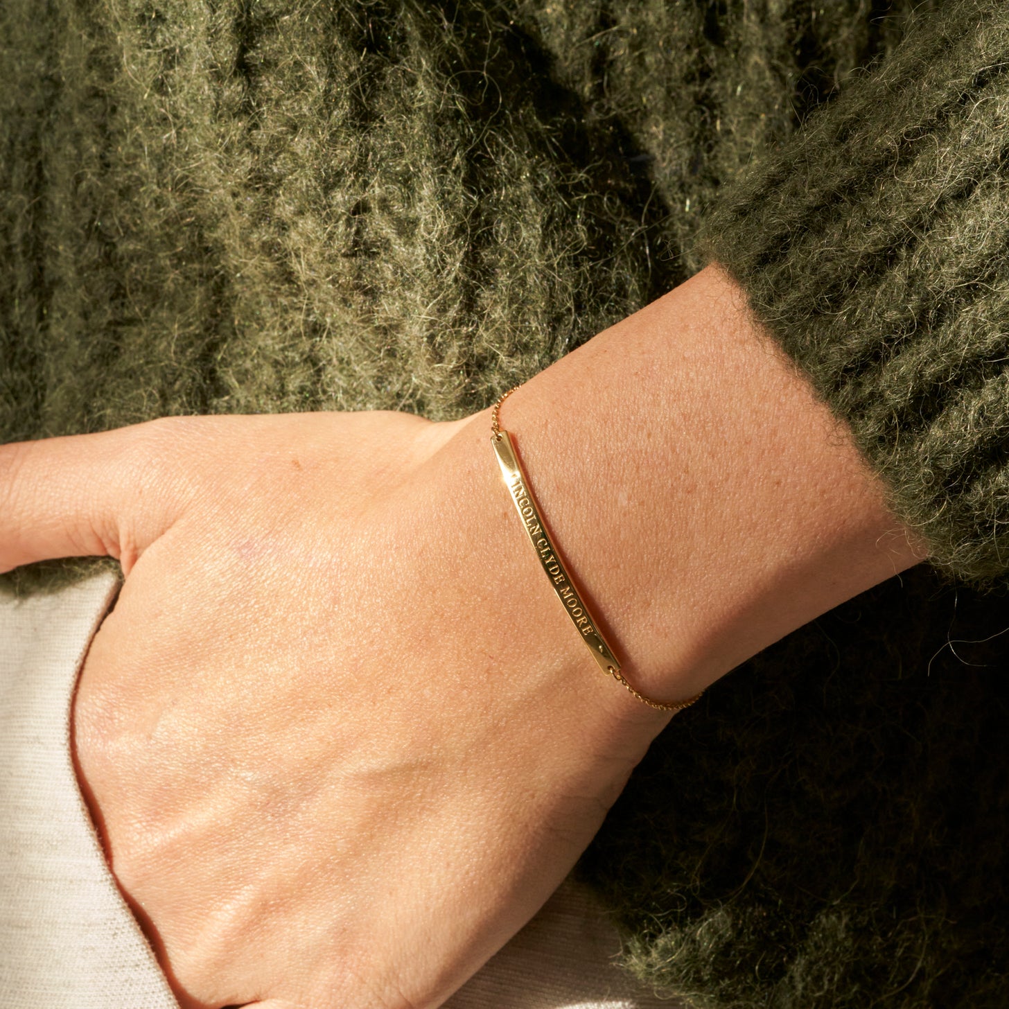 Personalized engraving of a name, coordinate, and message gold bar bracelet