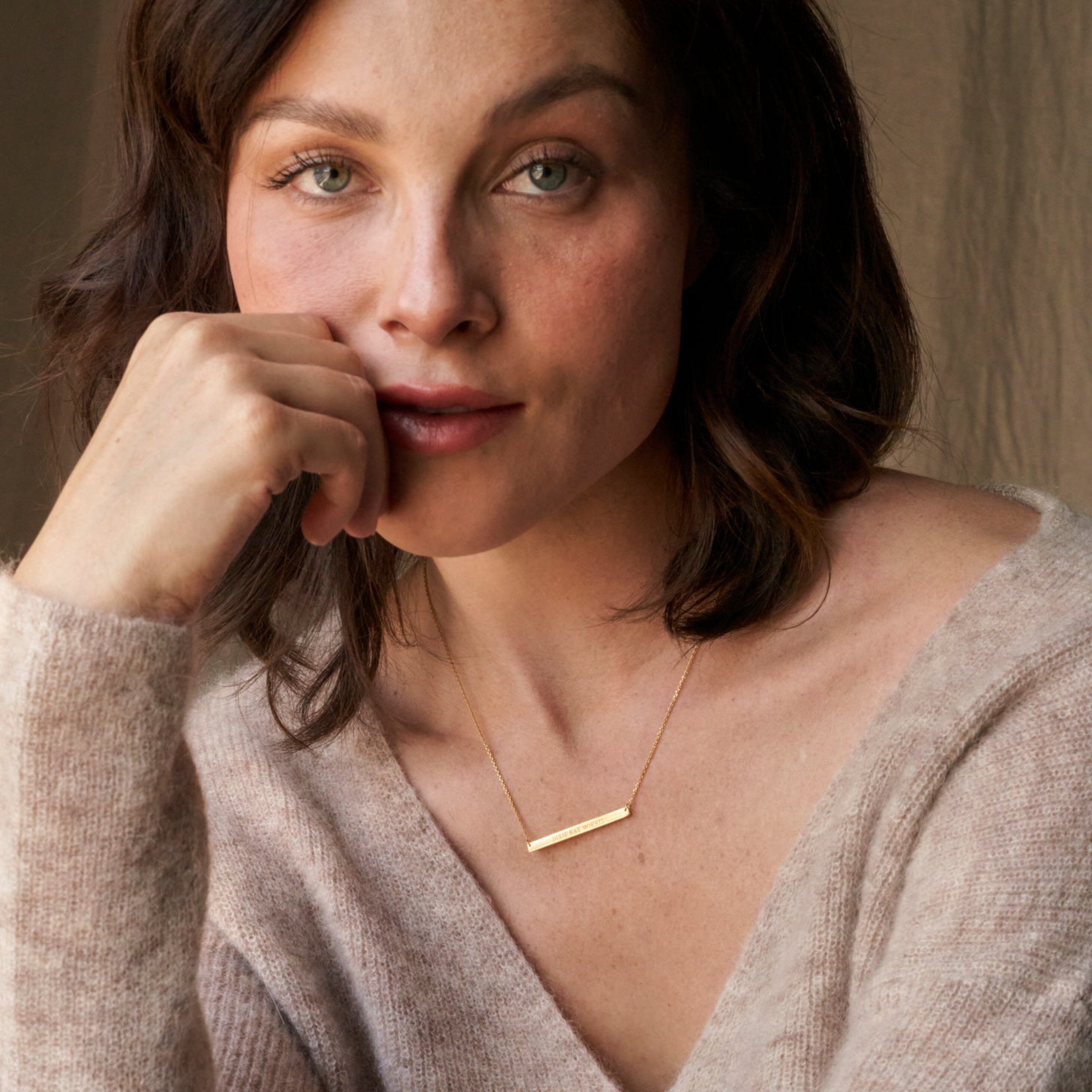 Beautiful gold nameplate necklace on a dainty cable chain, with inscribed names, affirmations, and coordinates