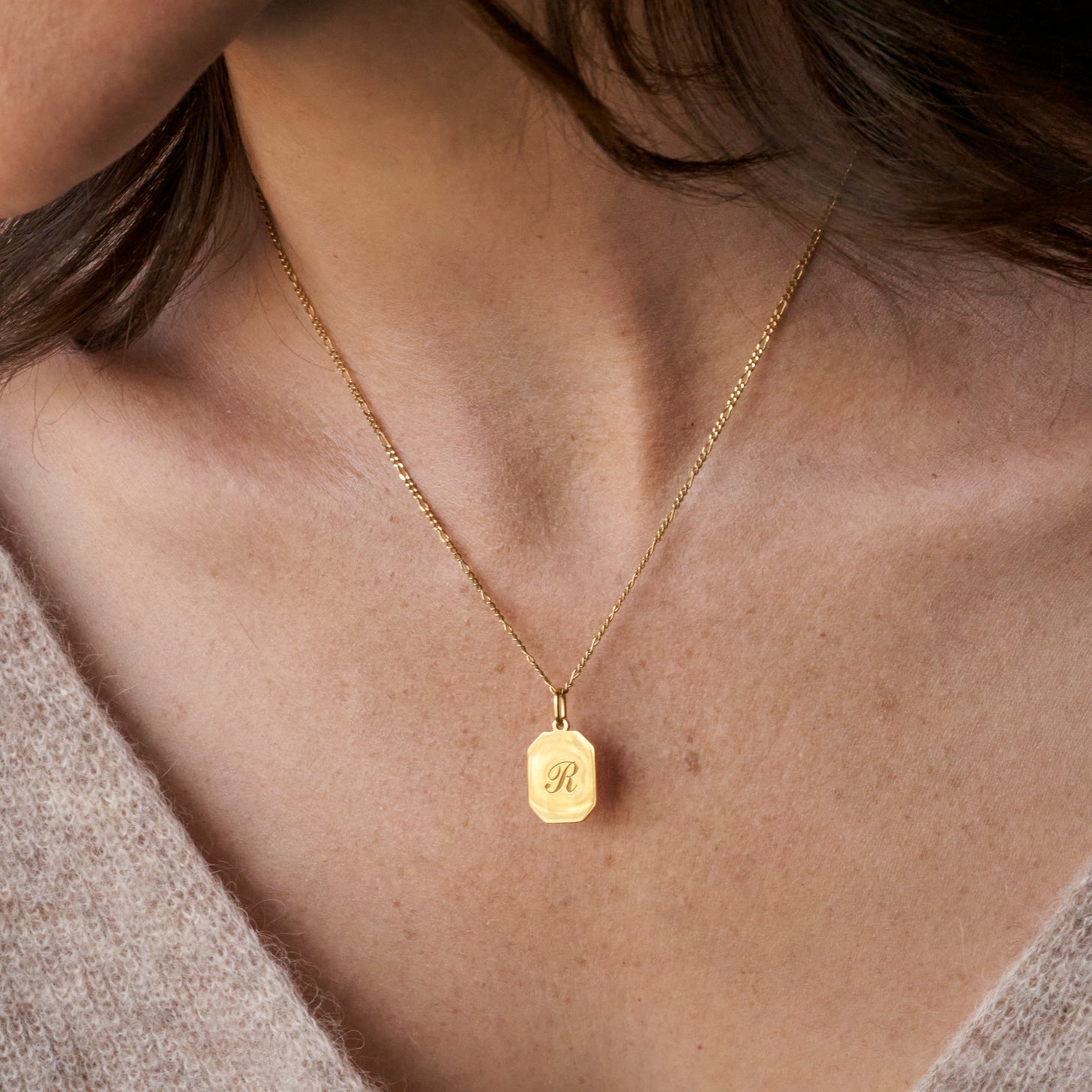 Custom engraved initials on our classic dog tag pendant necklace in a classic script font, with a dainty figaro chain