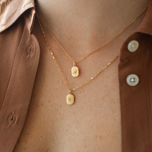 Small gold tag pendant necklaces with engraved initials