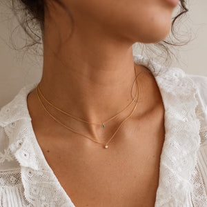 Model wears our Josie Birthstone Necklaces, featuring emerald and white sapphire birthstones