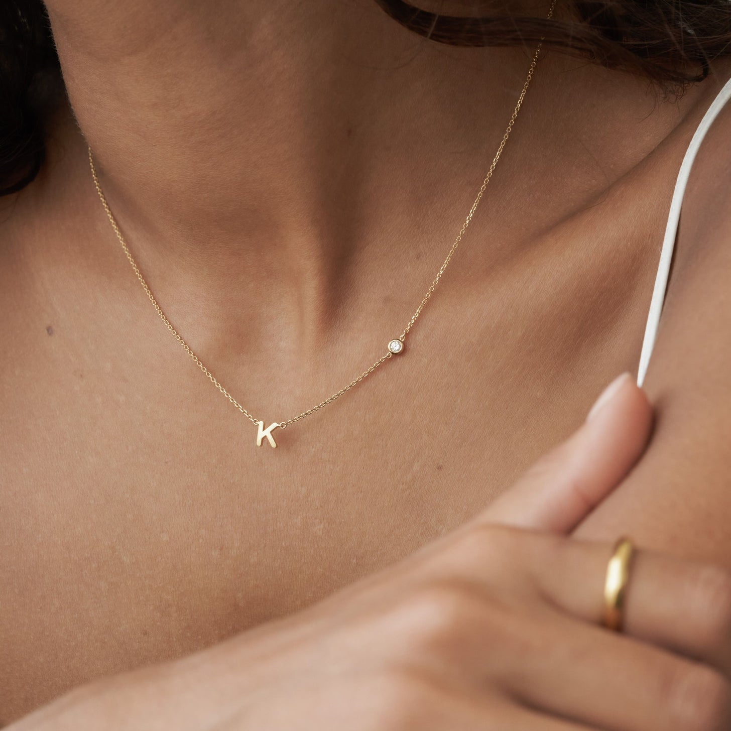 Dainty custom initial and cubic zirconia stone on a simple necklace