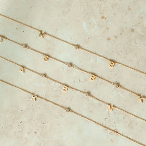 Examples of initials and stones on our Louisa Letter Necklace