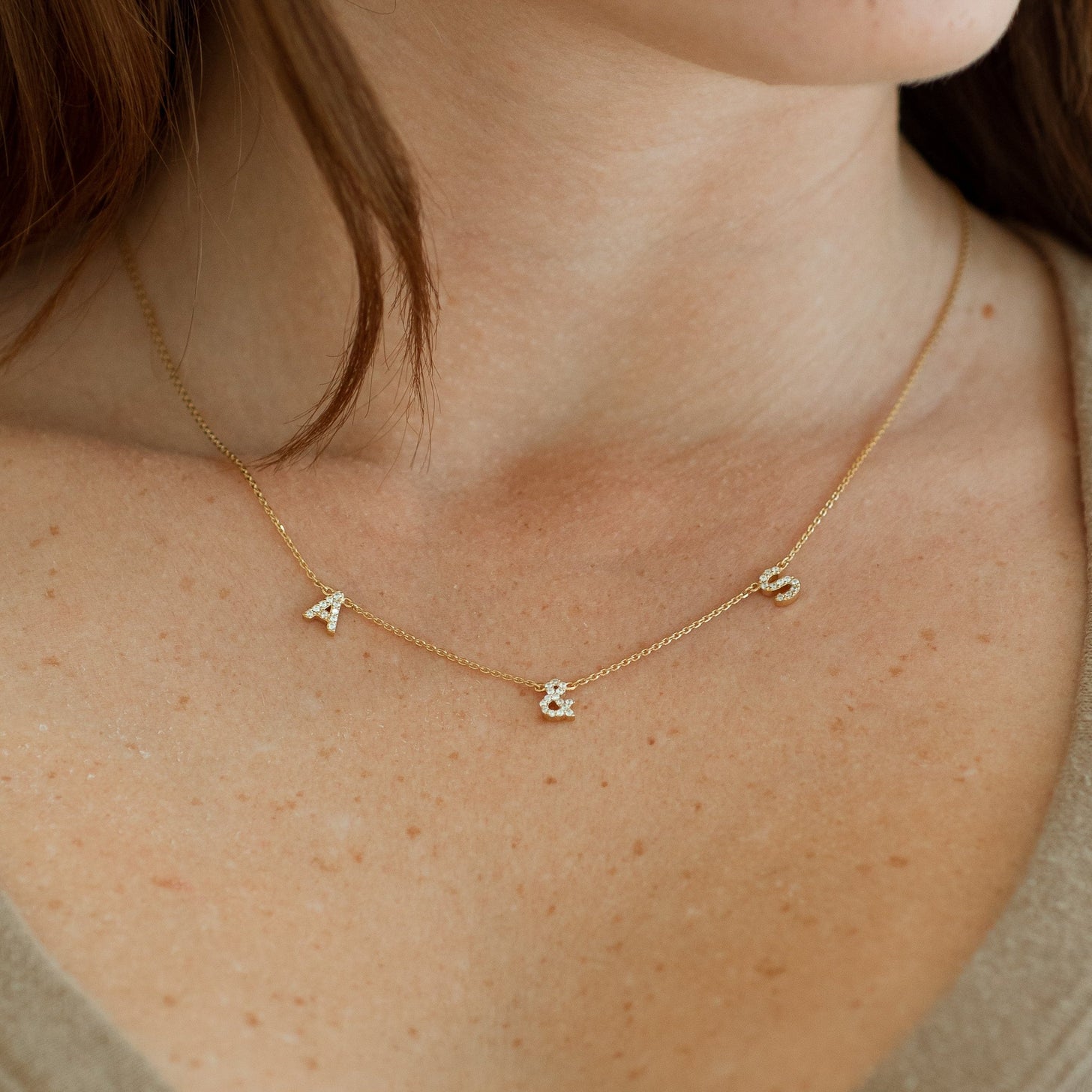 Dainty letters and numbers in cubic zirconia stones on a cable chain necklace