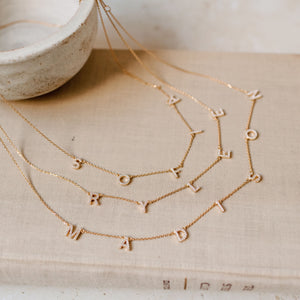 Examples of Luciana Pave Name Necklaces with spaced letters