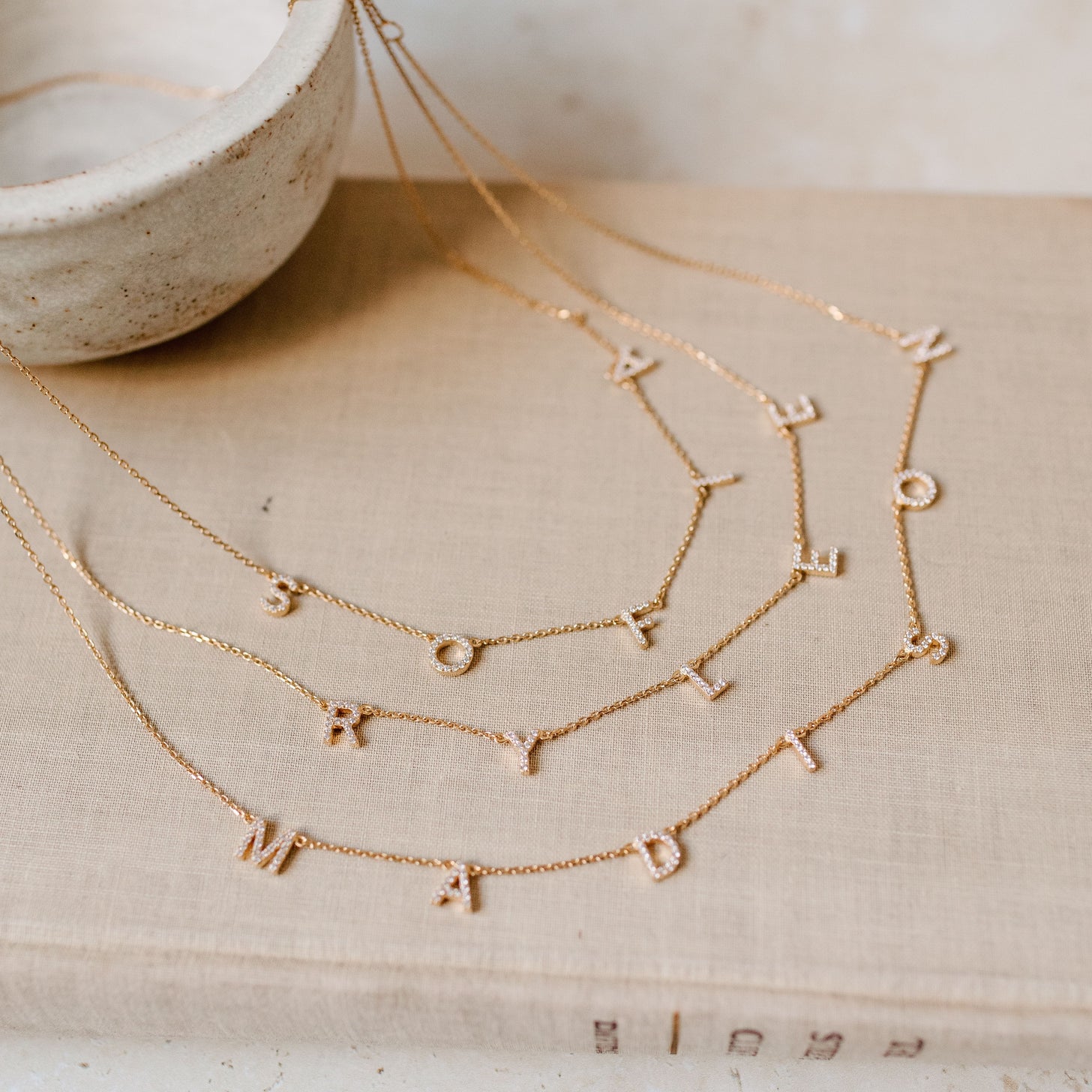 Examples of Luciana Pave Name Necklaces with spaced letters