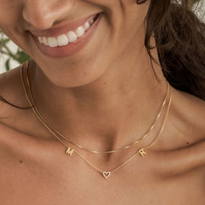 Modern font initial necklace with a shimmering CZ stone heart