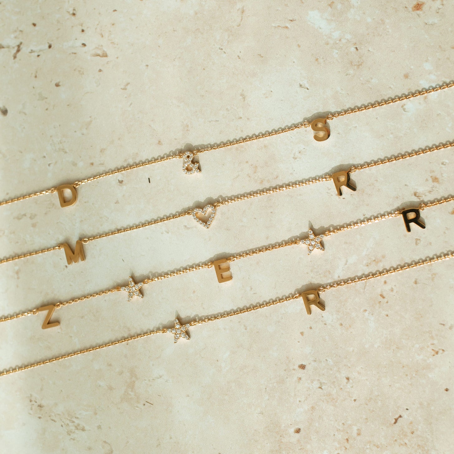 Examples of the Luna Initials Necklace with cubic zirconia stone hearts and stars