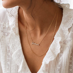 Model wearing custom Nahomie Name Necklace with mini link chain necklace