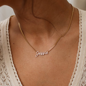 Close up of gold custom Naia Pave Name Necklace