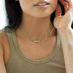 Model wearing gold pave Nancy Name Necklace