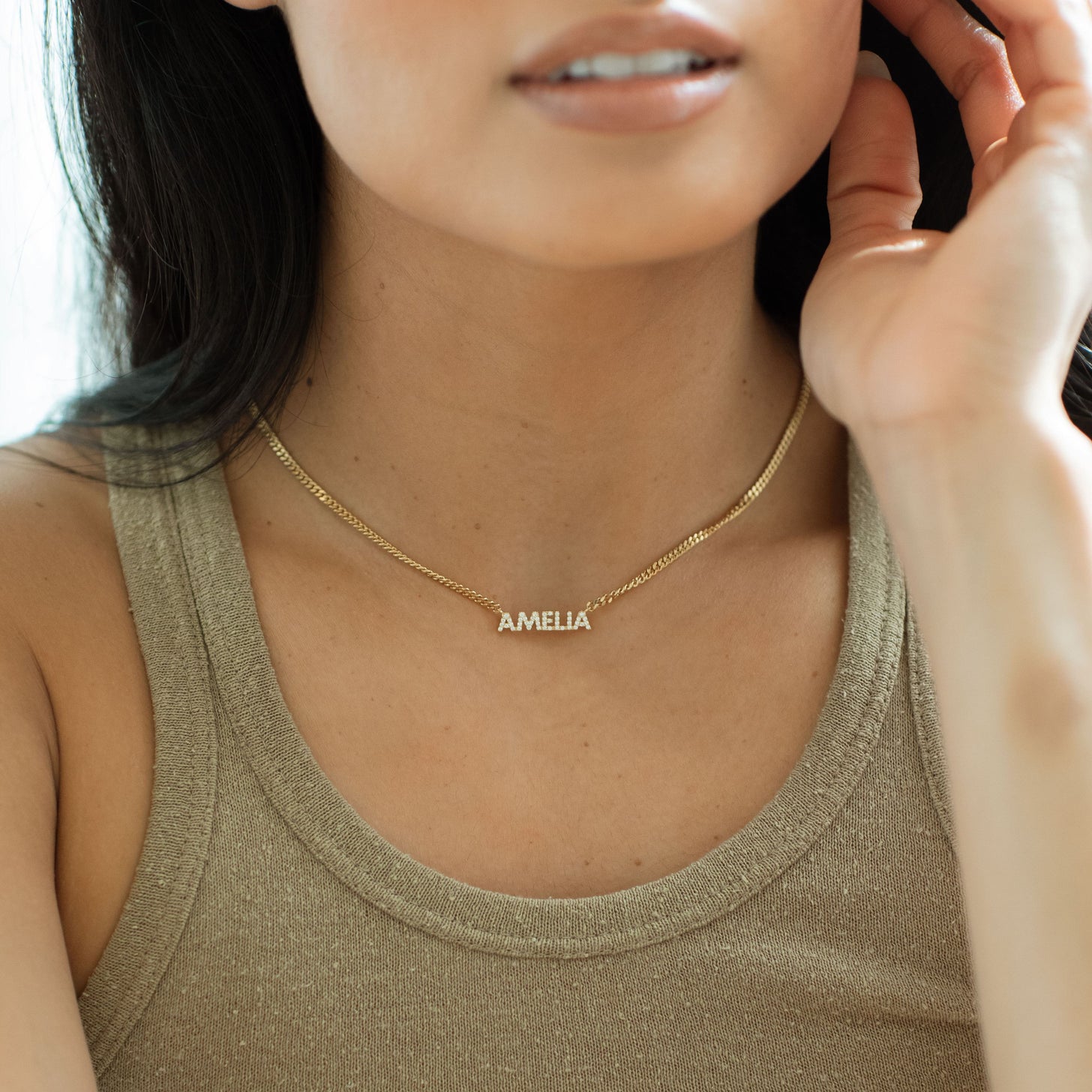 Model wearing gold pave Nancy Name Necklace