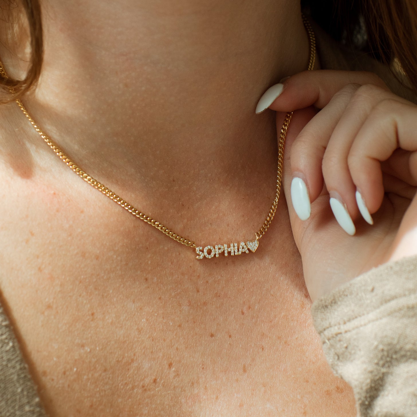 Model wearing shimmering pave name necklace with curb chain
