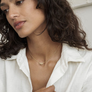 Model wearing dainty gold Nari Korean Name Necklace with figaro chain
