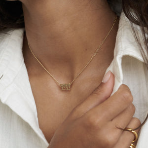 Model wearing Nari Korean Name Necklace by Grace Personalized with a dainty figaro chain