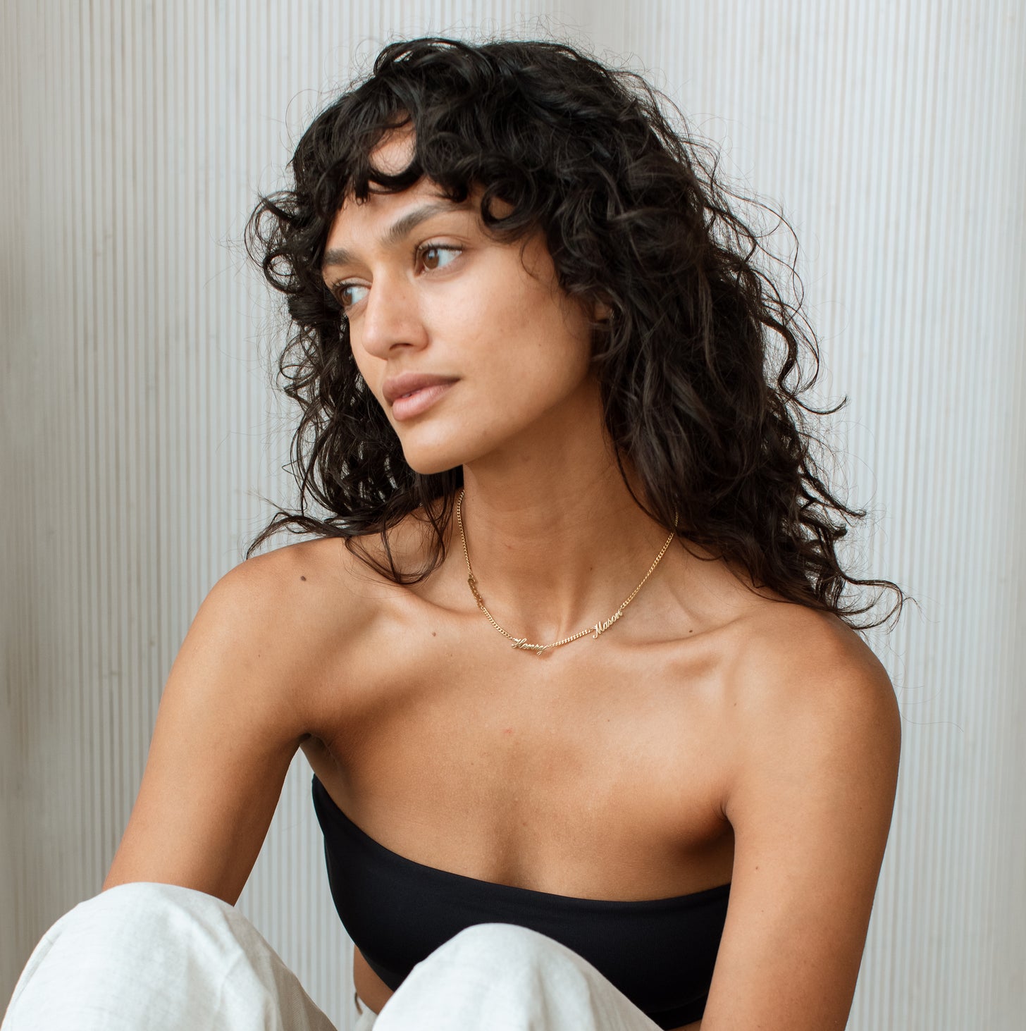 Top body shot of model wearing Narisa Multiple Name Necklace with 3 names