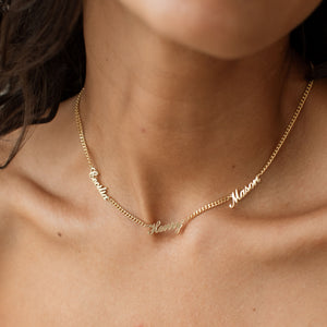 Model wearing 3-name gold Narisa Multiple Name Necklace with curb chain