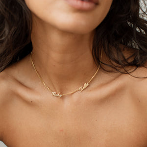 Model wearing 2-name gold Narisa Multiple Name Necklace with curb chain