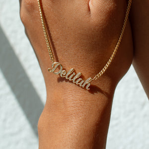 Gold custom name necklace with cubic zirconia stones and a bold curb chain