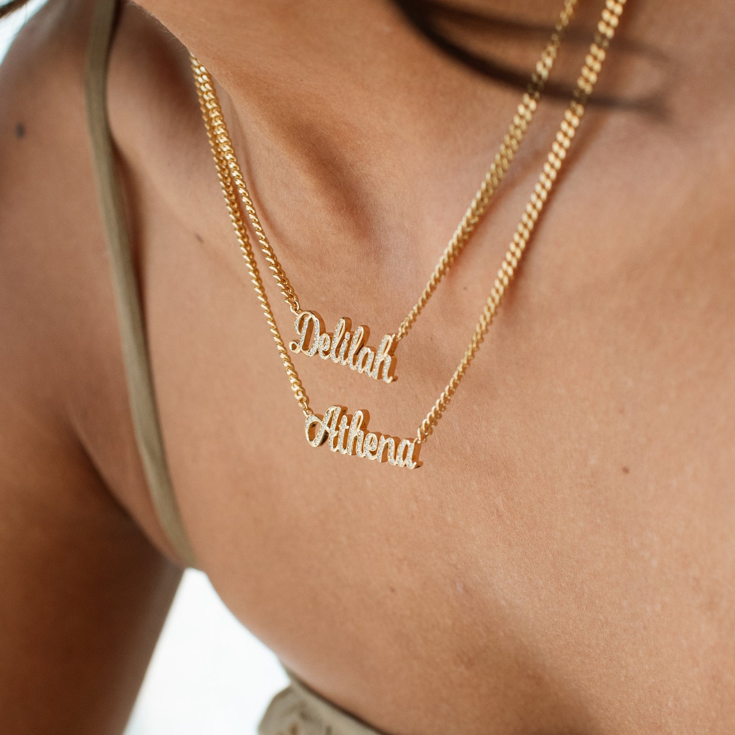 Necklace with pave name plate in gold and cubic zirconia stones, along a bold chain
