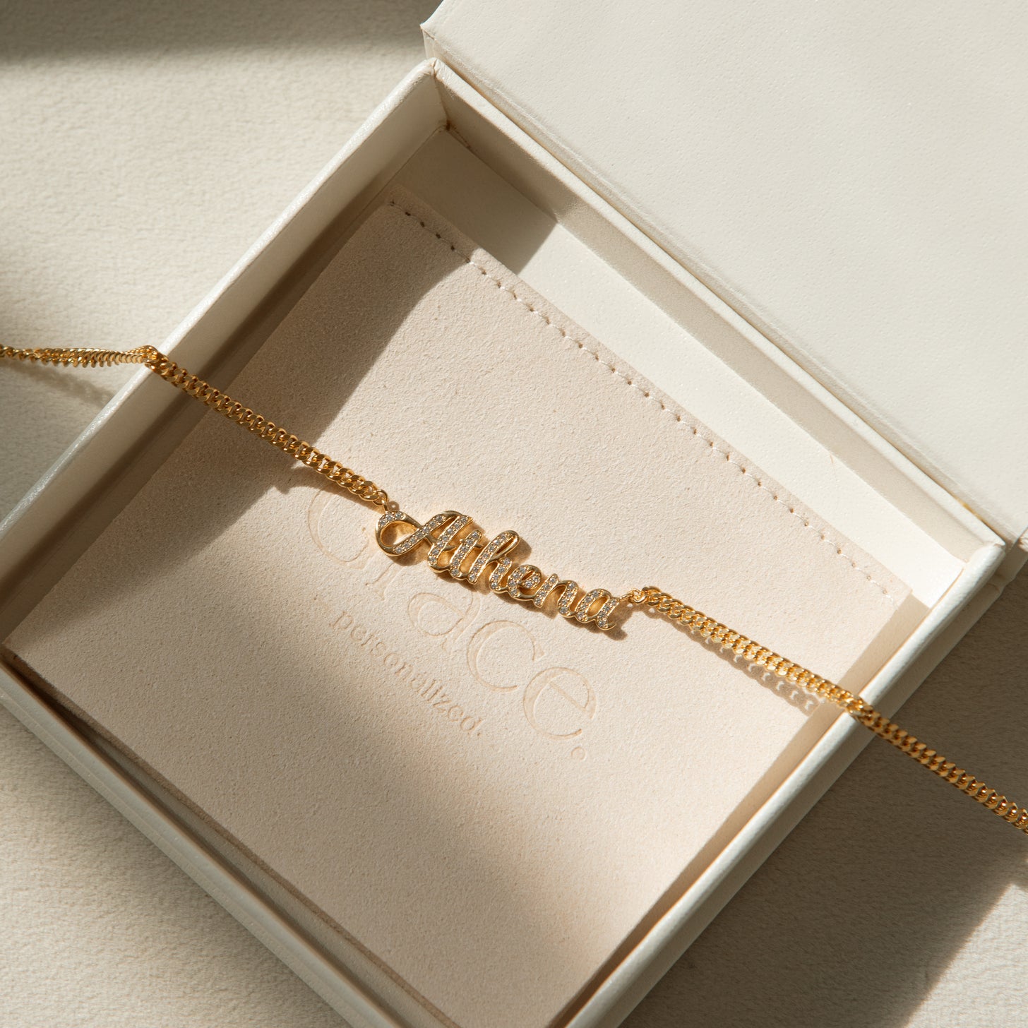 Custom name necklace in cursive font with diamond cubic zirconia letters. Personalize the necklace with a name, word, or number