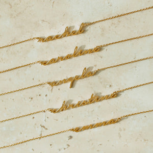 Gold examples of custom name necklace in cursive script font
