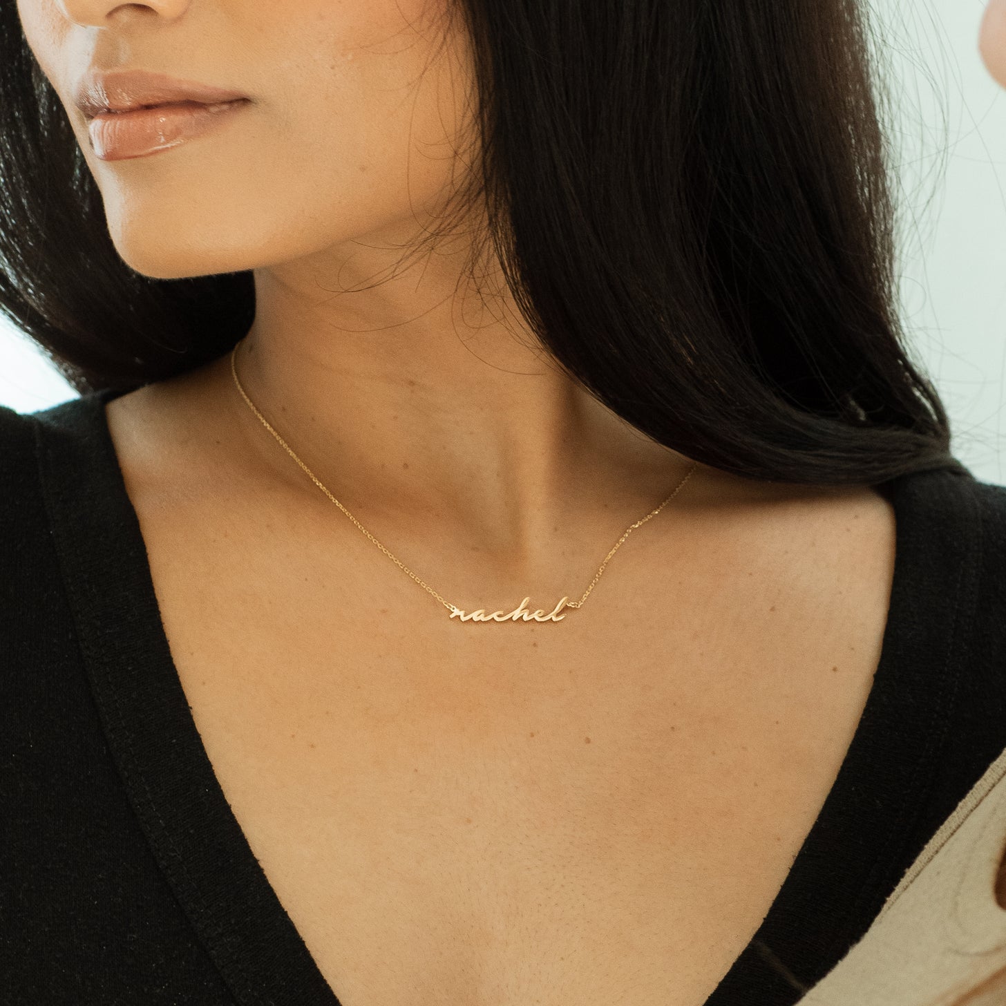 Custom kids' name necklace in cursive font on a dainty cable chain