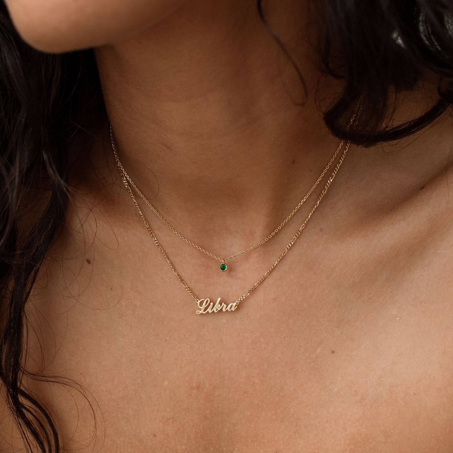 Model wears a Libra zodiac necklace, paired with our emerald Josie Birthstone Necklace
