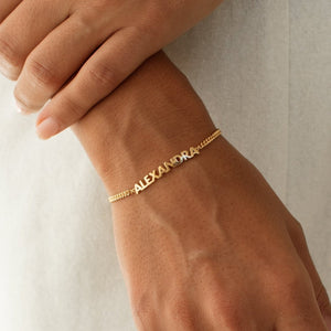 Close up of the gold Nelly Name Bracelet by Grace Personalized