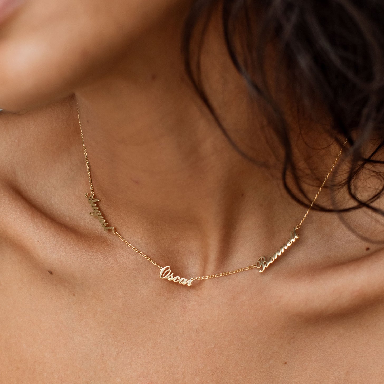 Model wearing 3-name Nelsey Multiple Name Necklace with figaro chain