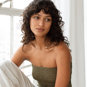 Model wearing 3-name gold Nelsey Necklace with multiple names