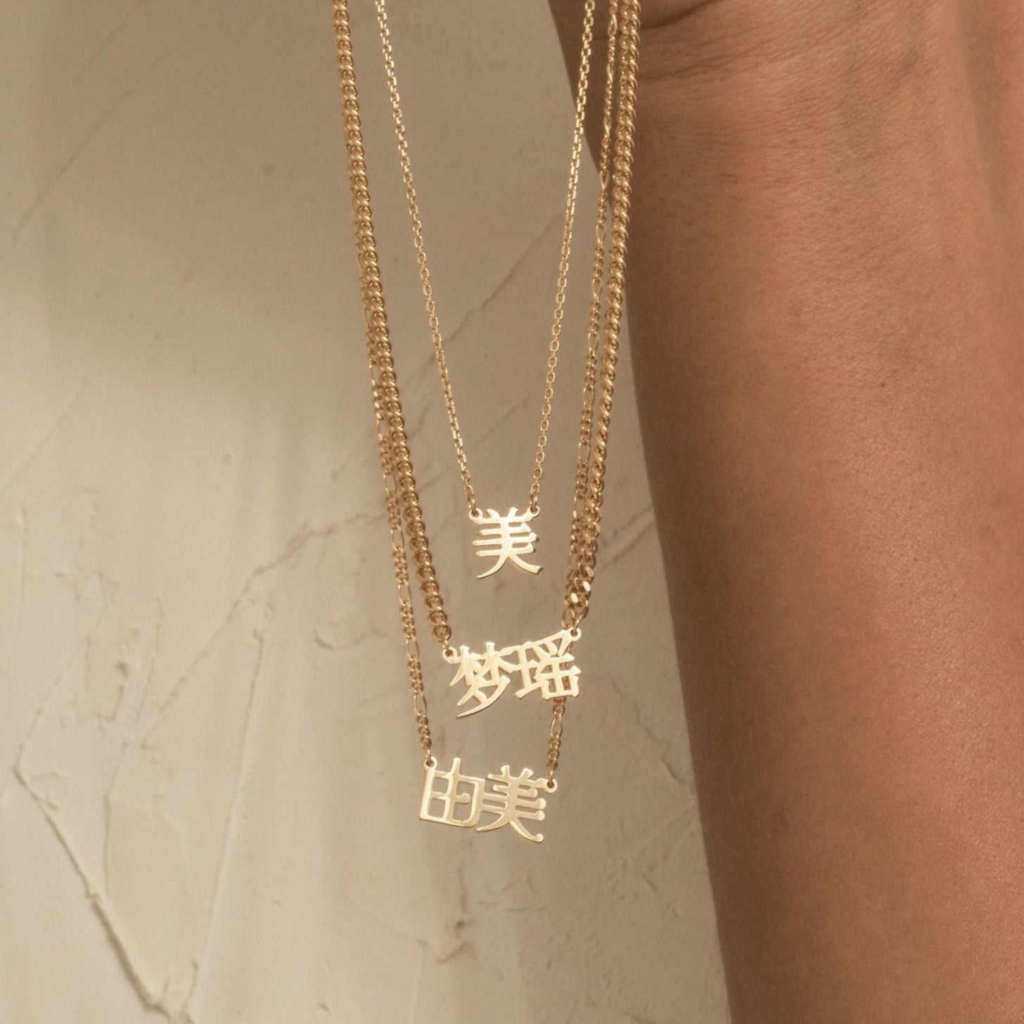 3 Nia Chinese Name Necklaces featuring cable chain, bold curb chain, and dainty figaro chain