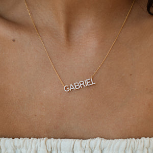 Model wearing gold pave Nina Name Necklace