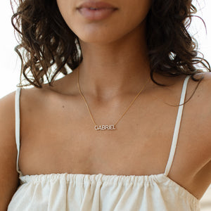 Model wearing pave Nina Name Necklace with white tank top