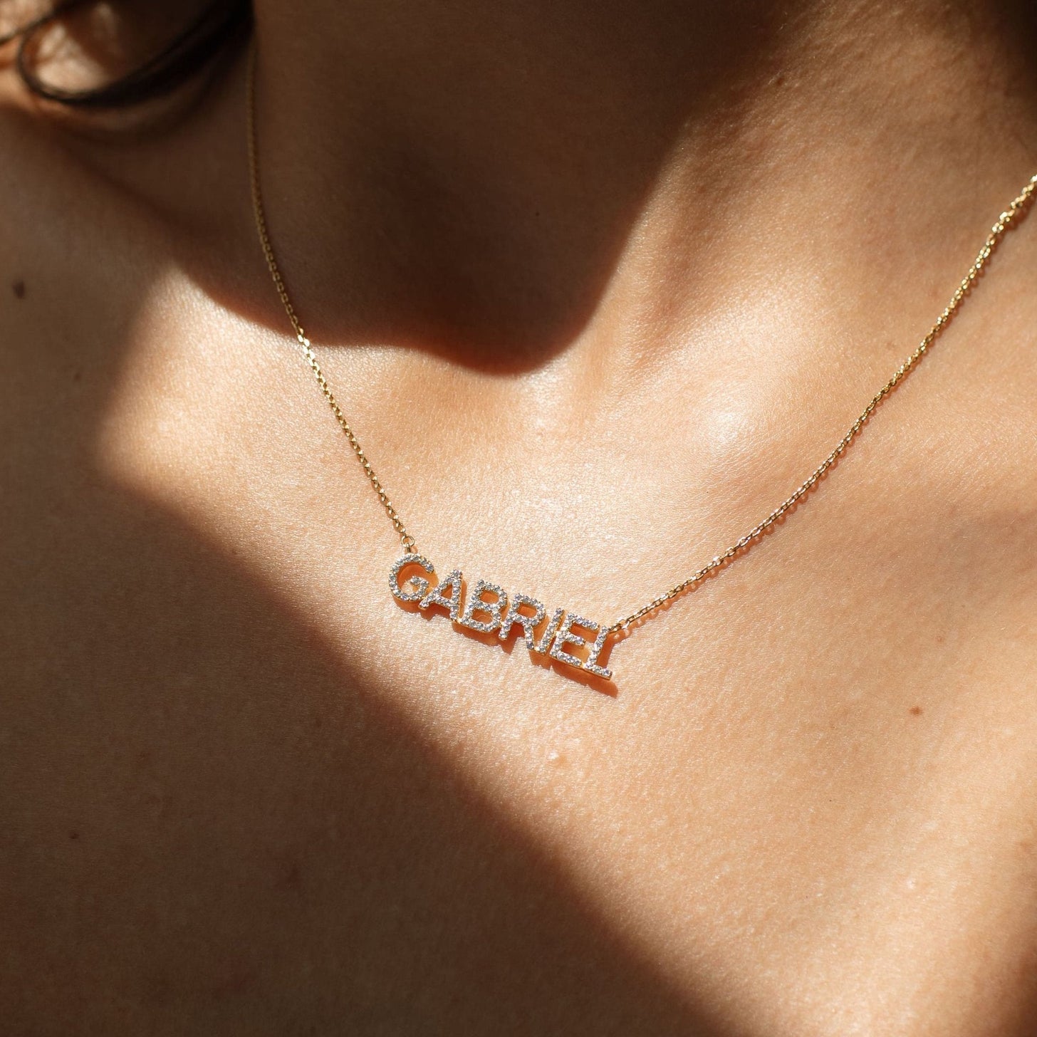 Model wearing custom pave name necklace, Nina Necklace