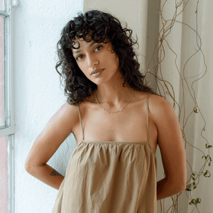 Model wearing multiple name necklace with pave letters