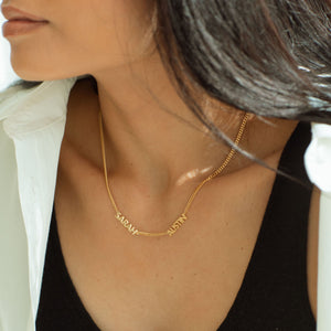 Model wearing 2-name gold Noelle Multiple Name Necklace