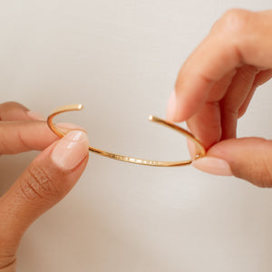Back engraving of the Rebecca Name Cuff Bracelet in gold