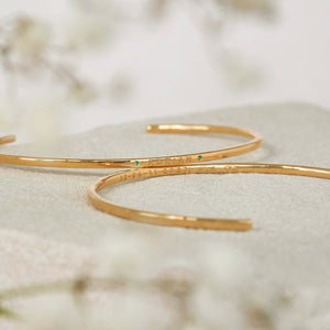 Ruby Birthstone Cuff Bracelets engraved on the front and back of the cuff, featuring birthstones on the front