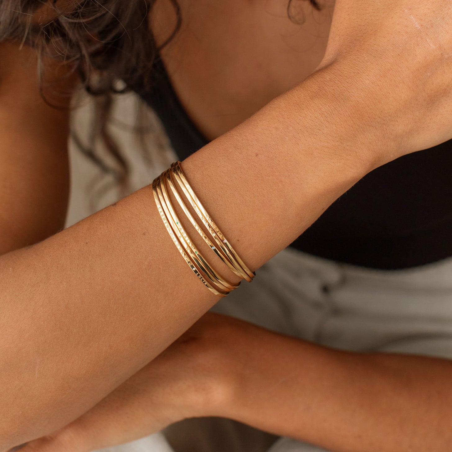 Stacked gold Ruby Birthstone Cuff Bracelets with engravings of names and messages