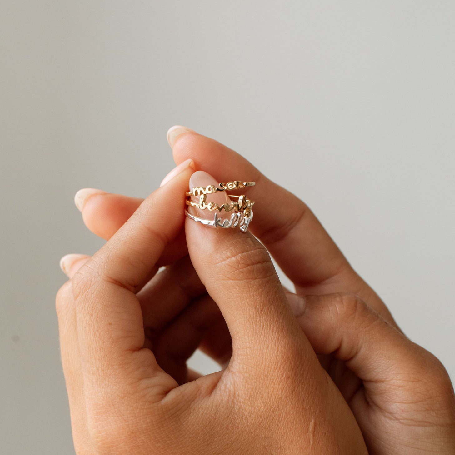 Gold and silver name rings in dainty cursive font
